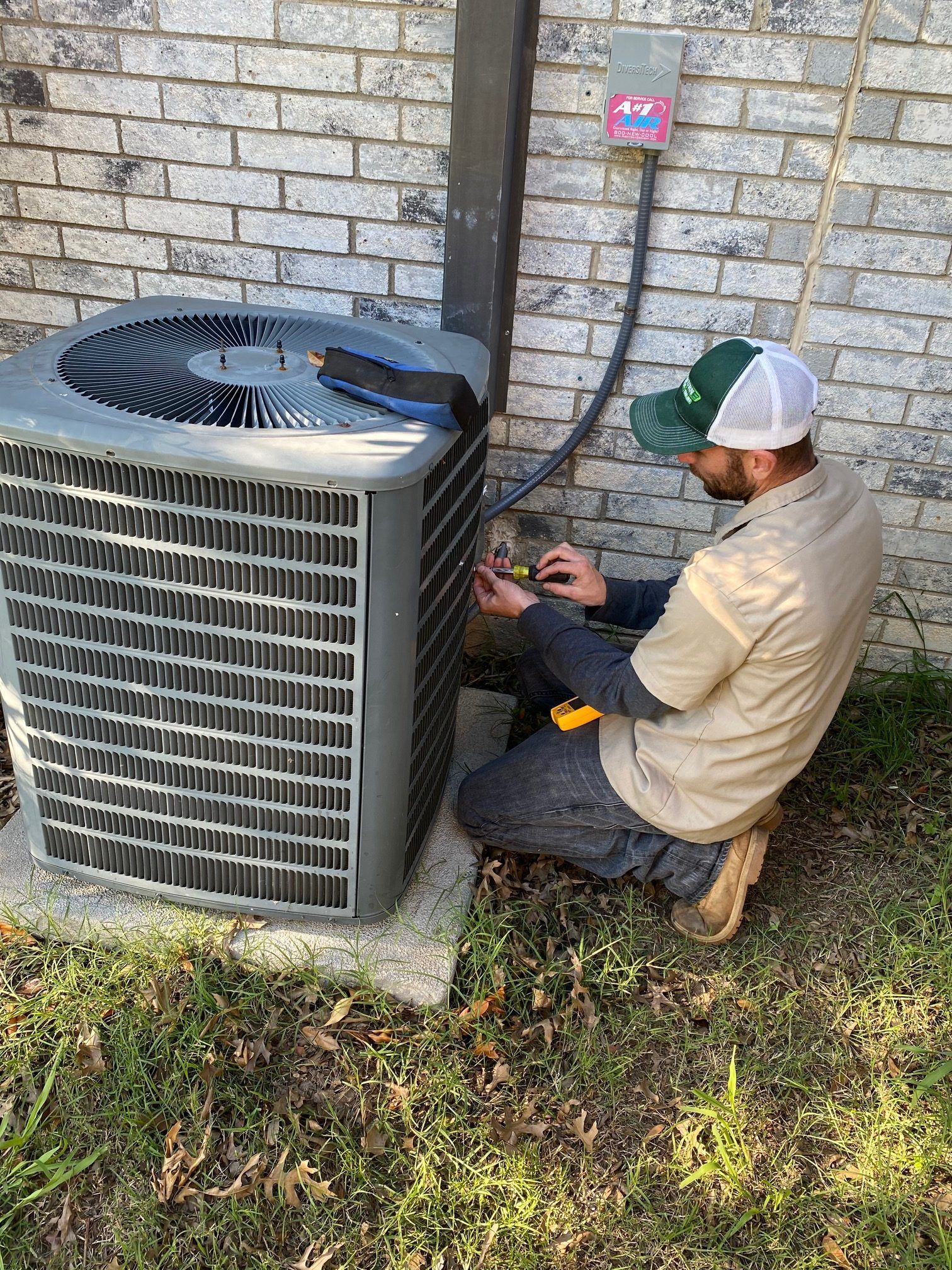 washburn-ac-repair Washburn Air tech performing AC maintenance in Grapevine, TX.