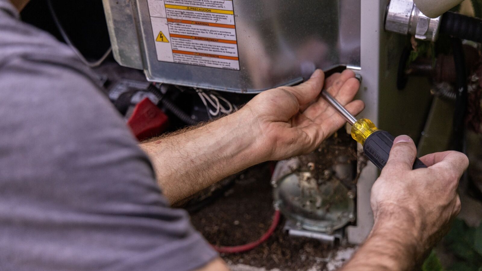HVAC-tech-working-on-heating-electrical Heating maintenance helps keep intensive units running all year.