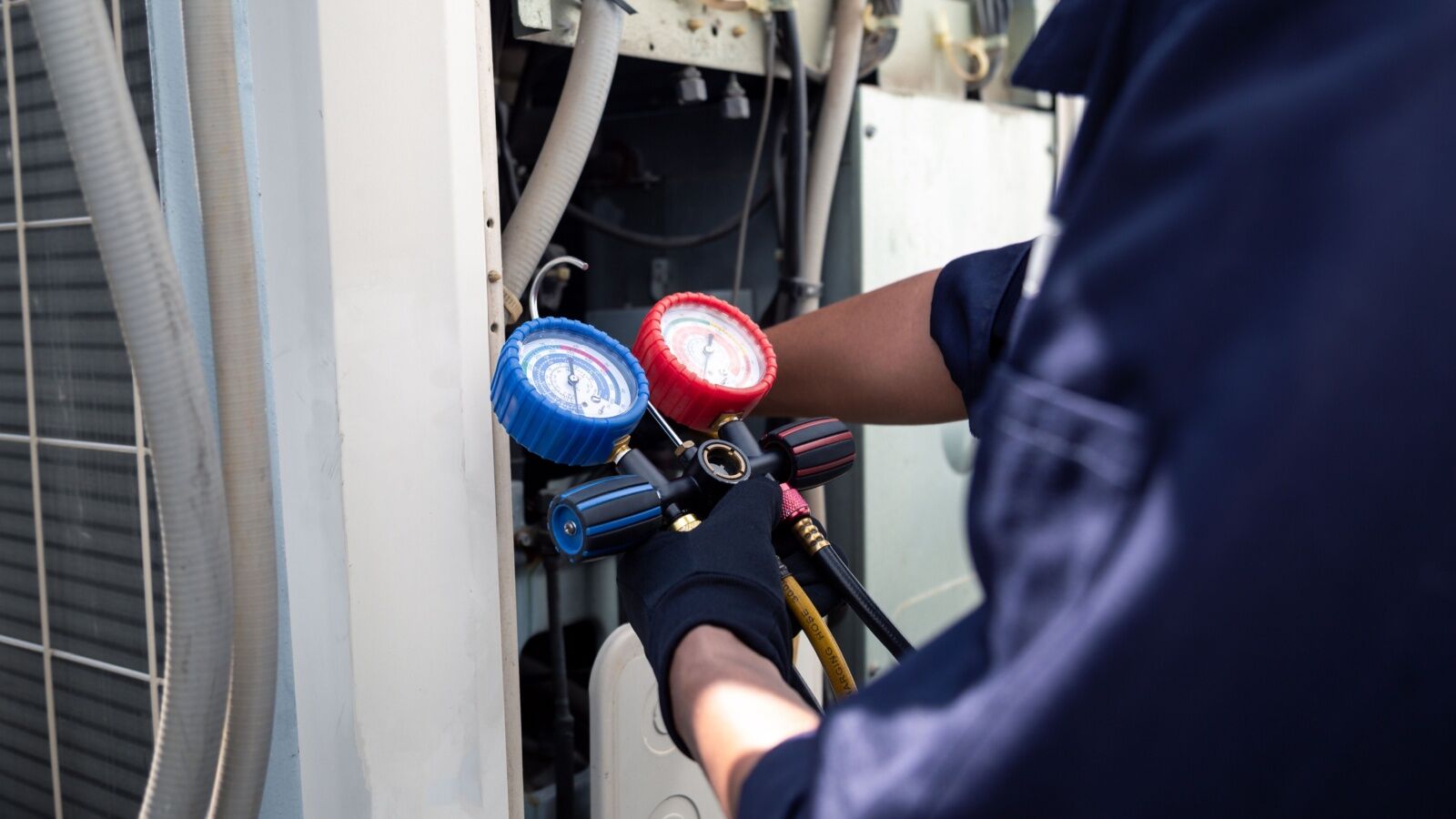 spring-hvac-tune-up Washburn Air refreshing a system's refrigerant levels during an HVAC tune-up.